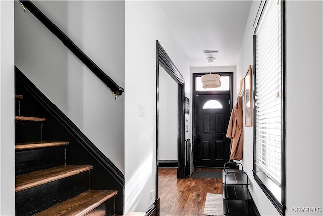 doorway with dark wood-type flooring