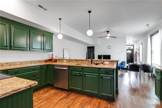 kitchen featuring pendant lighting, dishwasher, sink, and green cabinetry