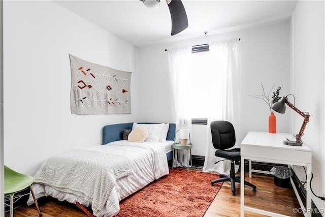 bedroom with hardwood / wood-style flooring and ceiling fan