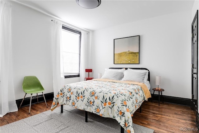 bedroom featuring dark hardwood / wood-style flooring and a baseboard radiator