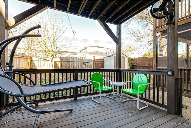 wooden deck featuring a shed