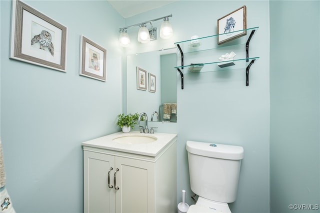 bathroom featuring toilet and vanity