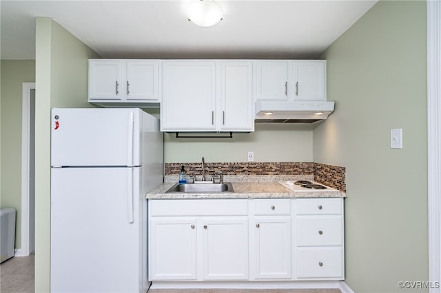 kitchen featuring light stone countertops, white appliances, white cabinetry, sink, and backsplash