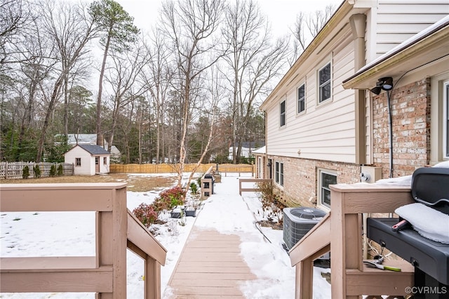 exterior space featuring central air condition unit and a shed