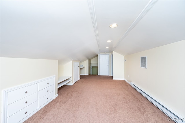 additional living space featuring a baseboard heating unit, light carpet, and vaulted ceiling