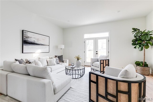 living room with french doors and light hardwood / wood-style flooring