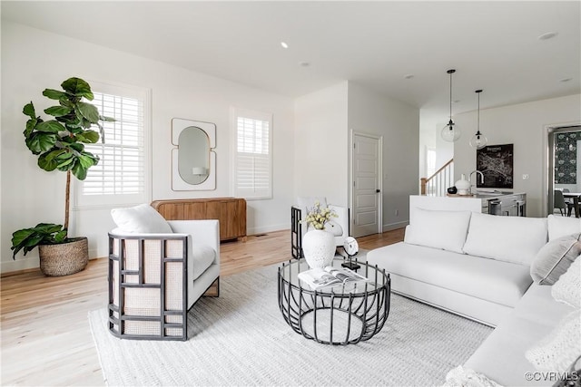 living room featuring light wood-type flooring and sink