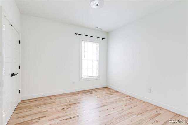 spare room featuring light hardwood / wood-style floors