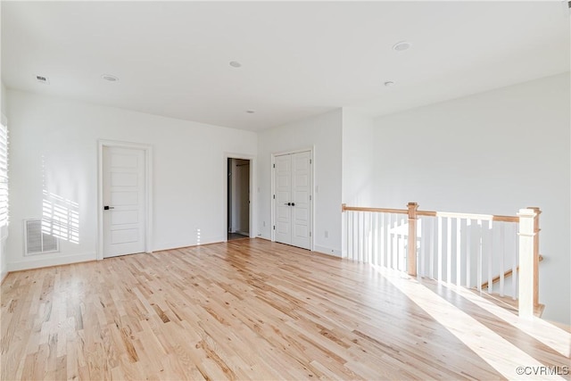 empty room with light hardwood / wood-style floors