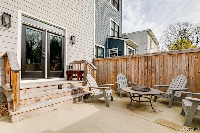 wooden deck featuring an outdoor fire pit