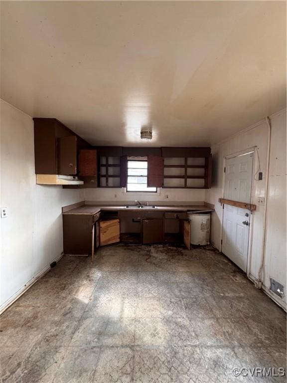 kitchen featuring dark brown cabinets and sink