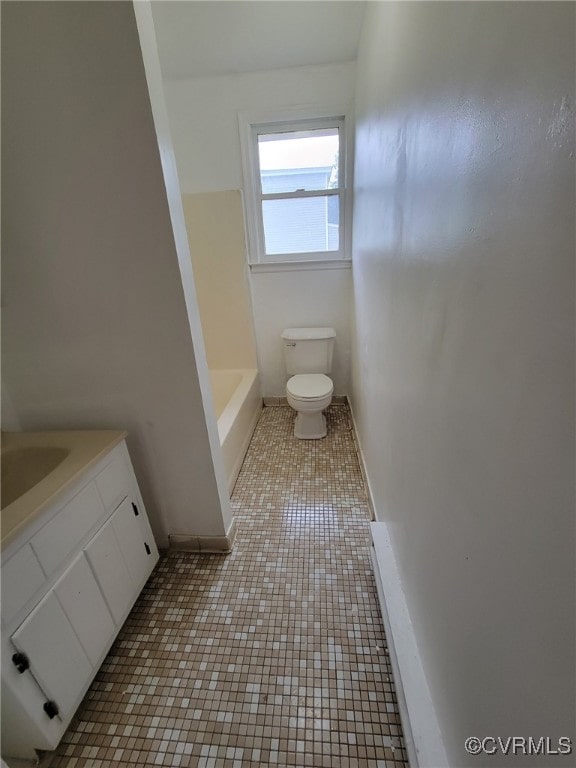 bathroom featuring toilet, vanity, and tile patterned floors