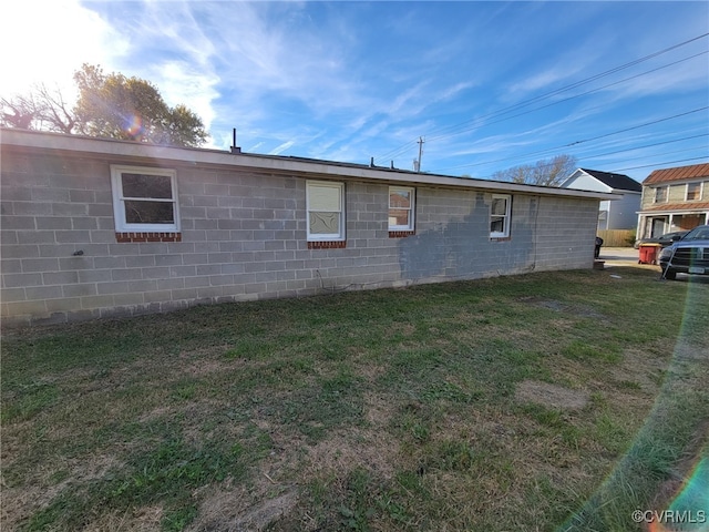 view of property exterior featuring a lawn