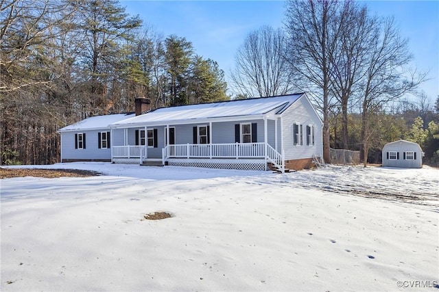 view of front of house with a shed and a porch