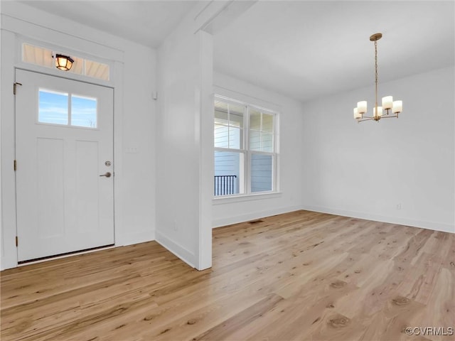 entryway featuring light hardwood / wood-style flooring and an inviting chandelier