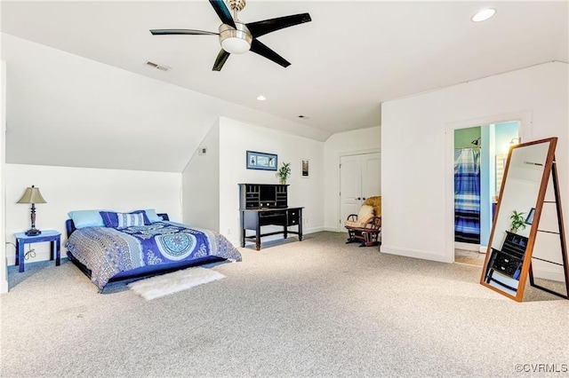 bedroom featuring carpet floors, vaulted ceiling, ceiling fan, and connected bathroom