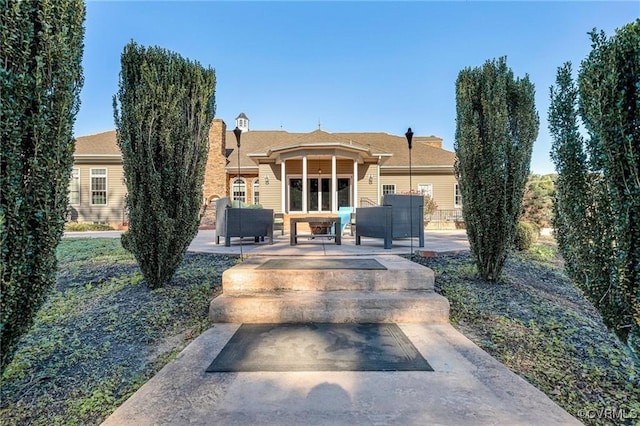 view of front of home featuring a patio area and an outdoor hangout area