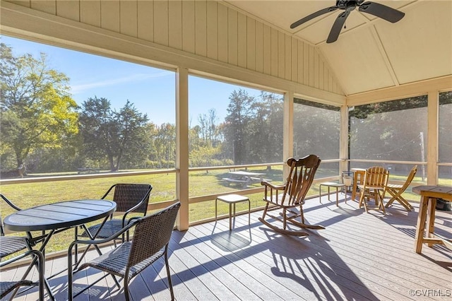 sunroom featuring ceiling fan, lofted ceiling, and a wealth of natural light