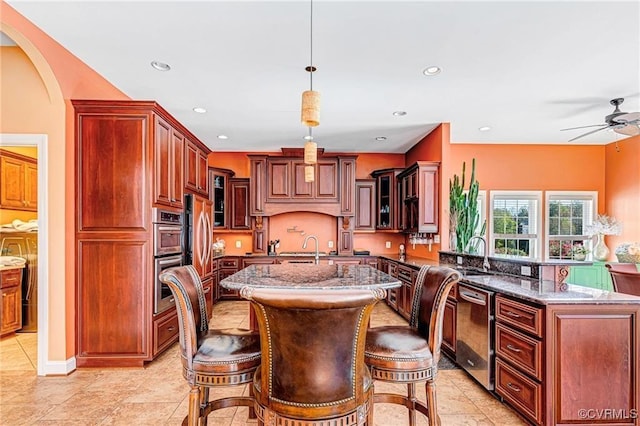 tiled dining area featuring ceiling fan and sink