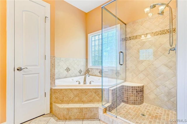 bathroom with tile patterned flooring and separate shower and tub