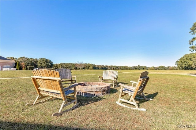 view of yard with a rural view and a fire pit