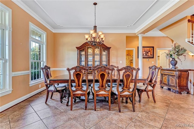 tiled dining room featuring decorative columns, a chandelier, and ornamental molding