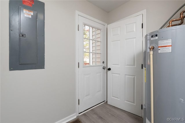 entryway featuring light wood-type flooring, electric panel, and water heater