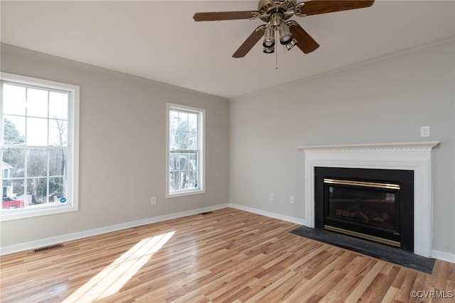 unfurnished living room featuring light hardwood / wood-style floors, ceiling fan, and ornamental molding