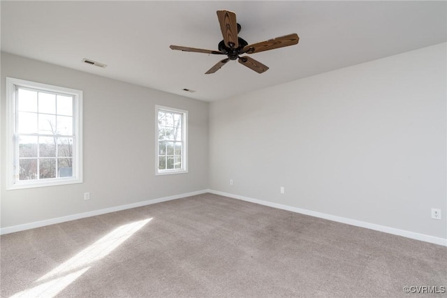 carpeted empty room featuring ceiling fan