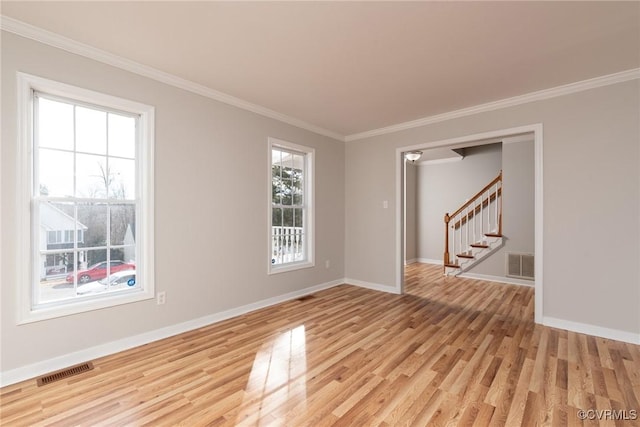 empty room with light hardwood / wood-style floors and ornamental molding