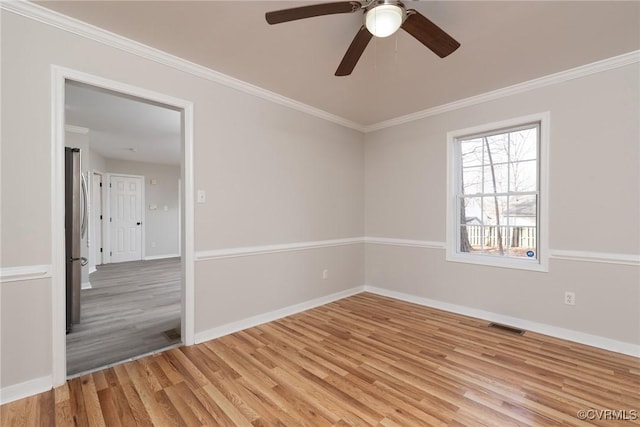 spare room with ceiling fan, crown molding, and light hardwood / wood-style floors