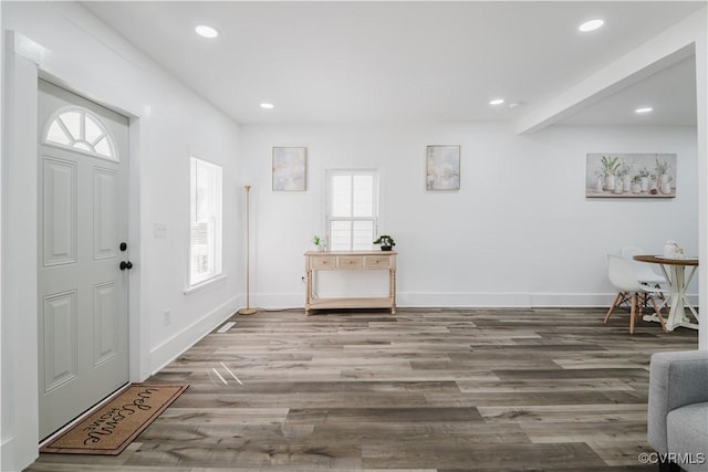 foyer entrance featuring beam ceiling and hardwood / wood-style flooring