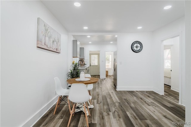 dining area featuring wood-type flooring and sink