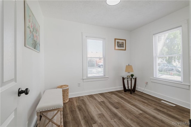 unfurnished room featuring a textured ceiling and dark hardwood / wood-style floors