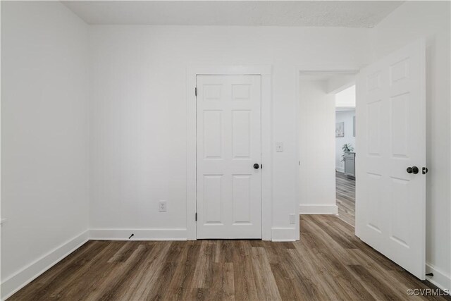 empty room featuring dark wood-type flooring