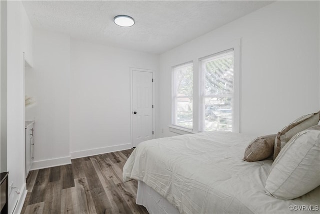 bedroom featuring wood-type flooring and a textured ceiling