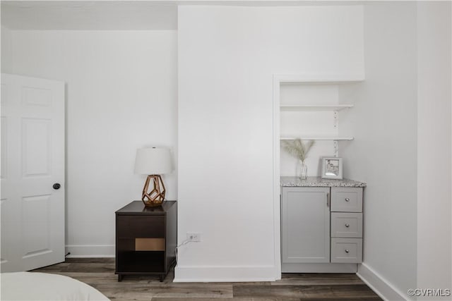 bedroom with dark wood-type flooring