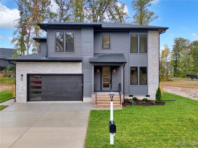 view of front of property featuring a front yard and a garage