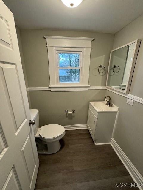 bathroom with hardwood / wood-style floors, vanity, and toilet