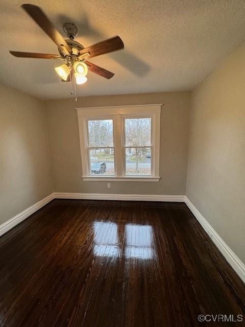 spare room featuring a textured ceiling, ceiling fan, and dark hardwood / wood-style floors