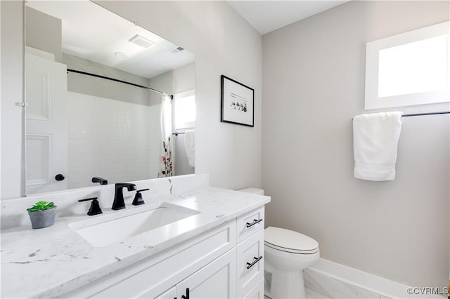 bathroom featuring vanity, toilet, and curtained shower