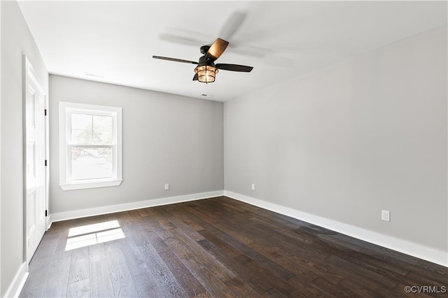 spare room with ceiling fan and dark wood-type flooring