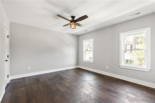 spare room with ceiling fan and dark hardwood / wood-style flooring