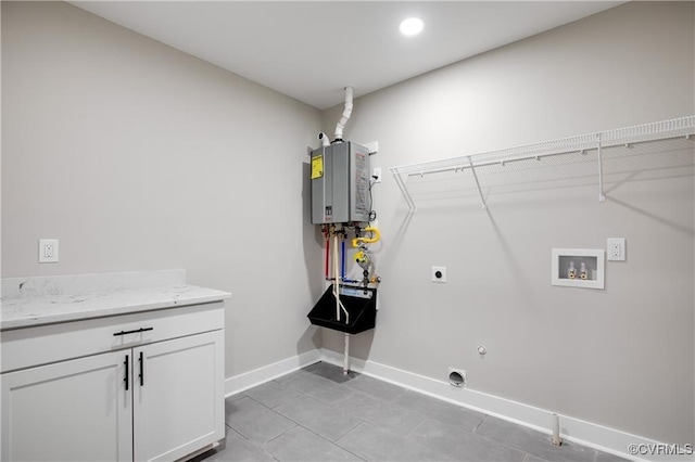 washroom with electric dryer hookup, cabinets, hookup for a gas dryer, tankless water heater, and hookup for a washing machine