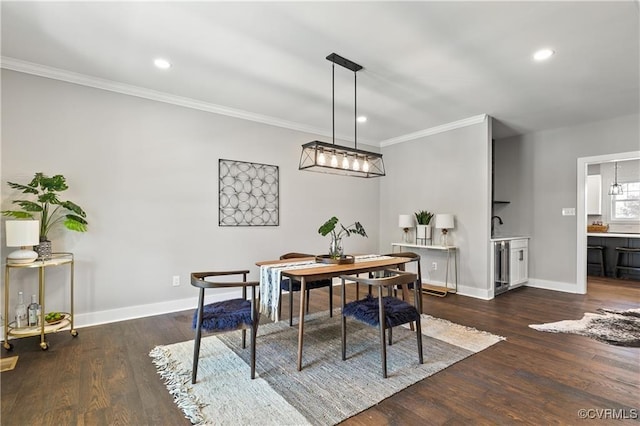 dining space with dark hardwood / wood-style floors and ornamental molding