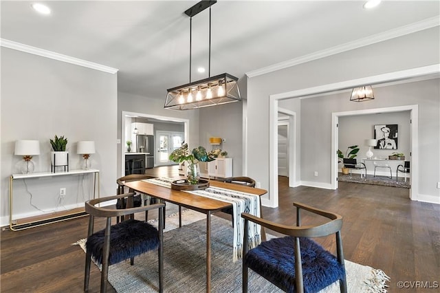 dining space with dark hardwood / wood-style floors and ornamental molding