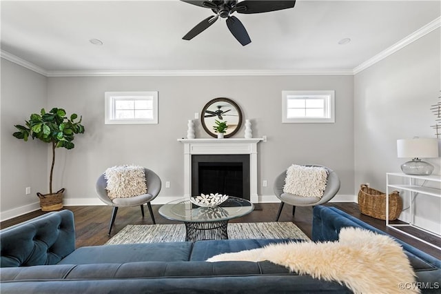 living area featuring crown molding, ceiling fan, a healthy amount of sunlight, and dark hardwood / wood-style floors