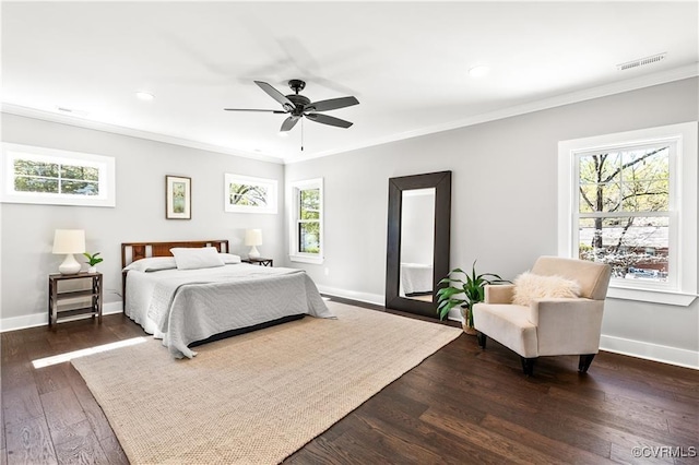 bedroom featuring ceiling fan, ornamental molding, and dark wood-type flooring