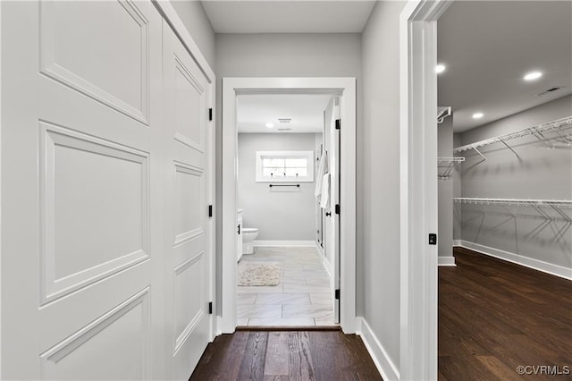 corridor featuring dark hardwood / wood-style flooring