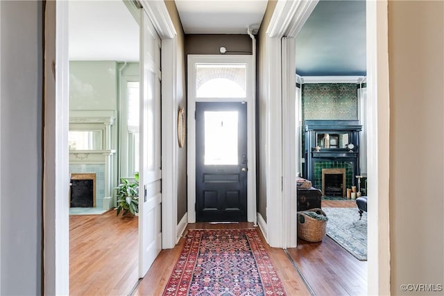 foyer with wood-type flooring and a fireplace